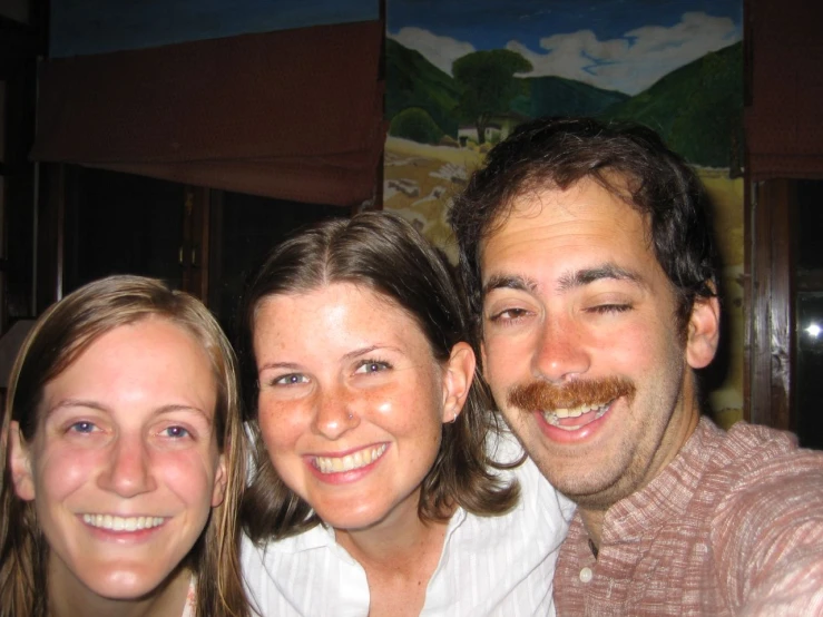 three people posing for a picture smiling