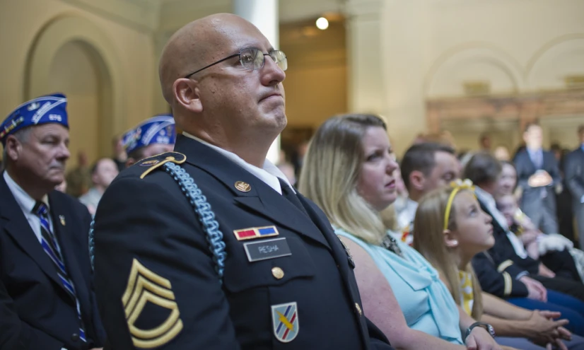 a few military officials are watching a ceremony