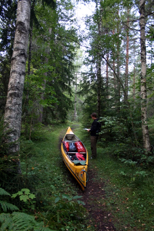 two canoes with one person standing by the canoe