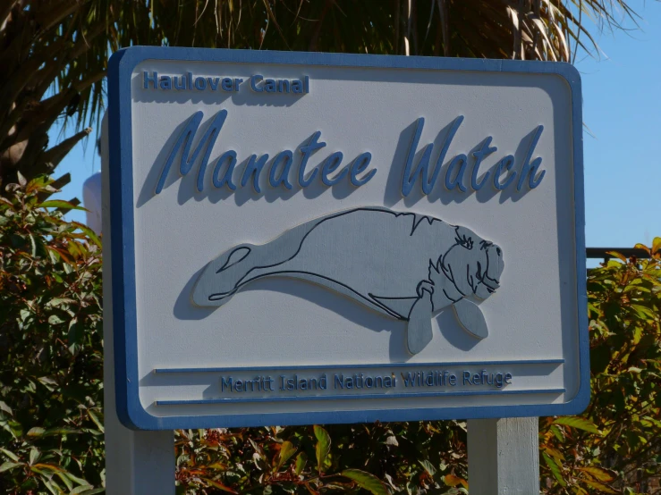 a sign on a roadside with a logo for a marine animal refuge