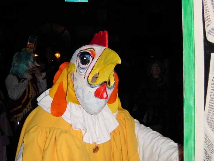 a man wearing a clown mask, orange vest and white shirt