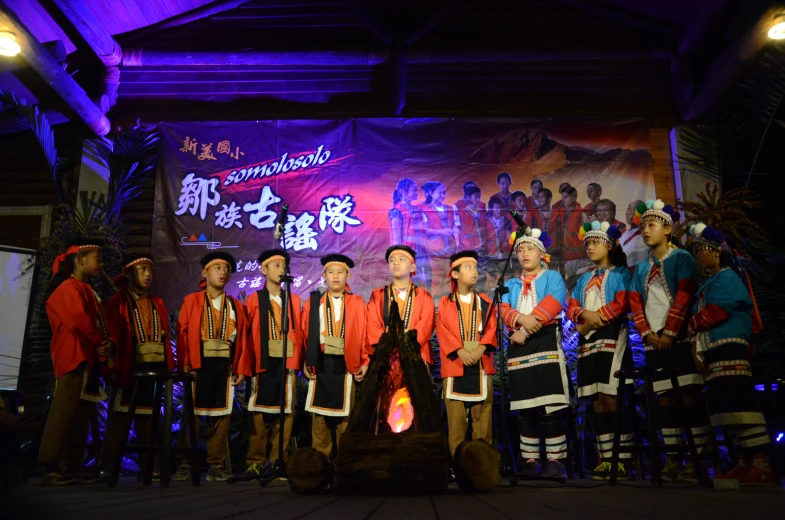 group of men in asian costume posing on stage