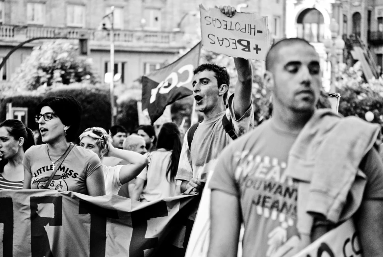 the protesters hold up signs in a protest