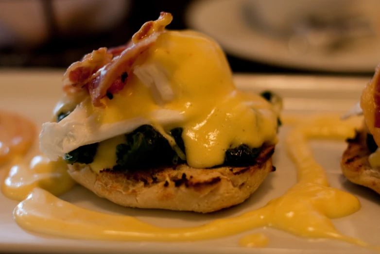 three small burgers on top of a white plate