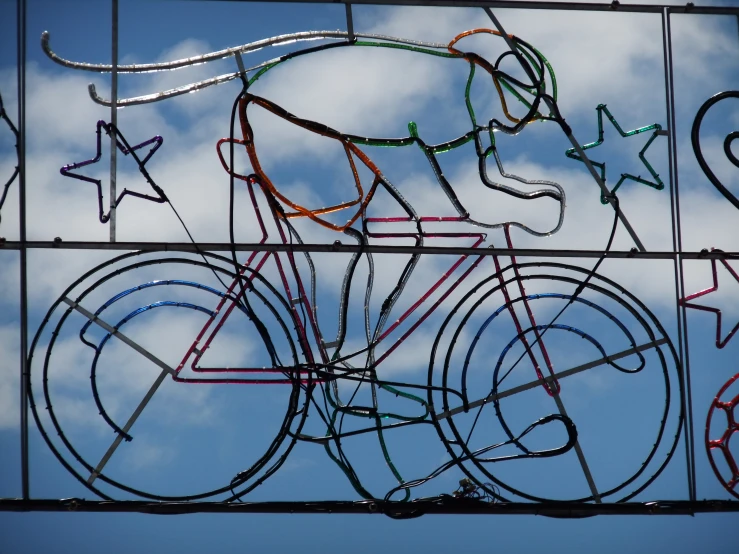 an artistic wire sculpture, consisting of bikes and stars