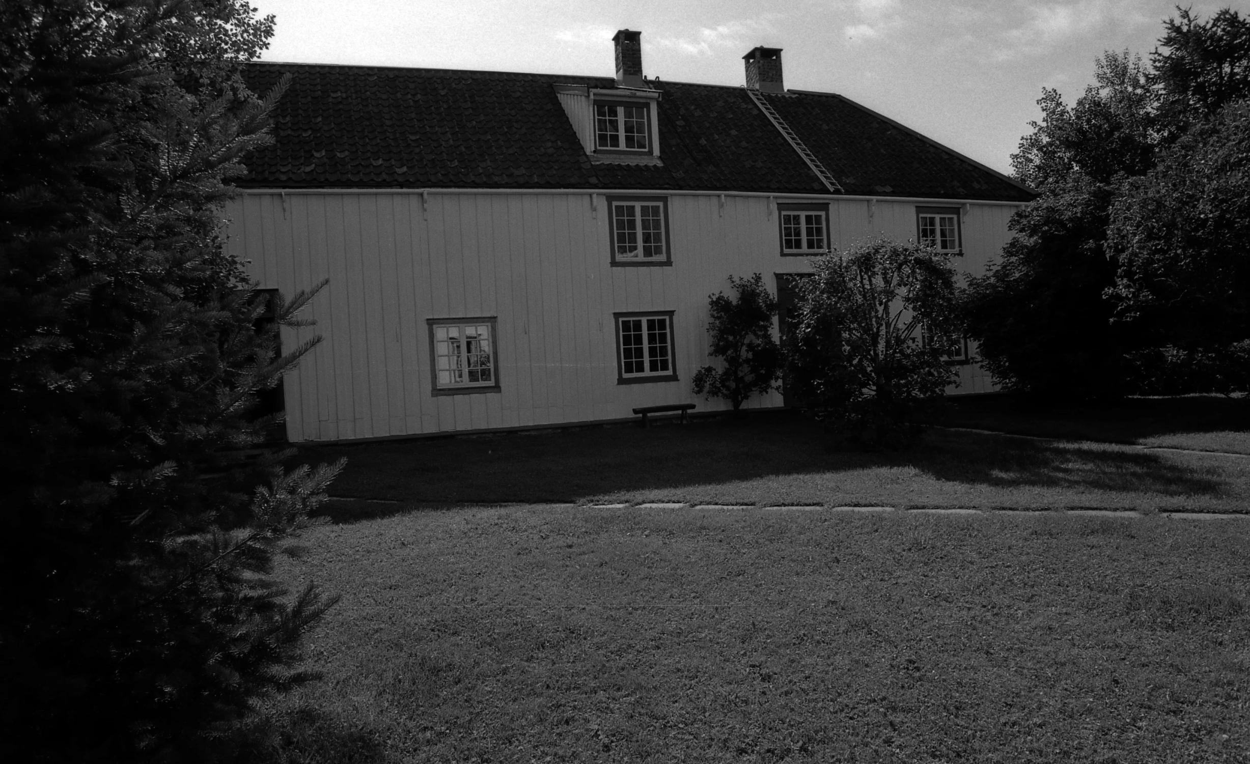 a white house with lots of windows and a sky background