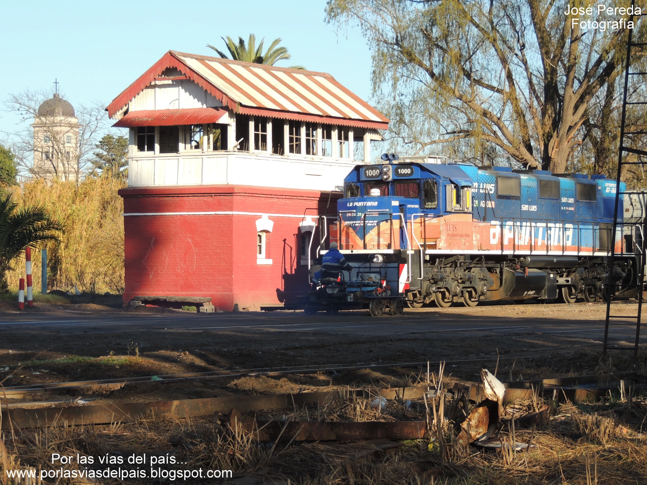 a train sits at the station by a building