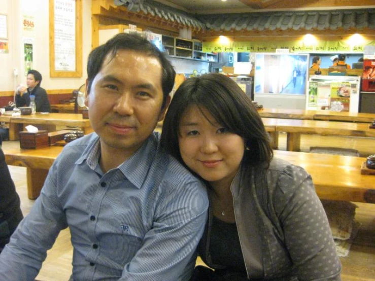 a man and a woman sitting at tables in a restaurant