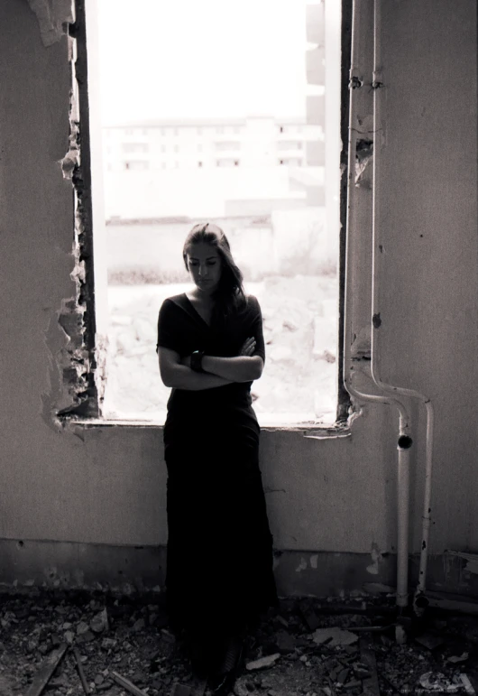 a woman sits in the corner looking out