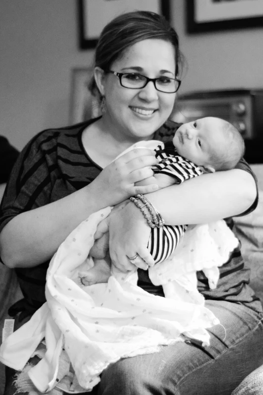 the woman is holding her newborn baby while holding it