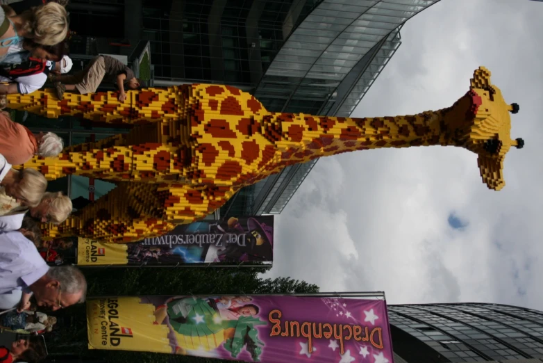 large lego giraffe made out of mini legos at an outdoor event