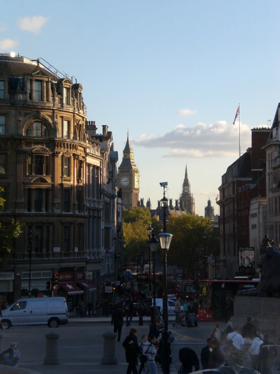 people walk along an urban street on a sunny day