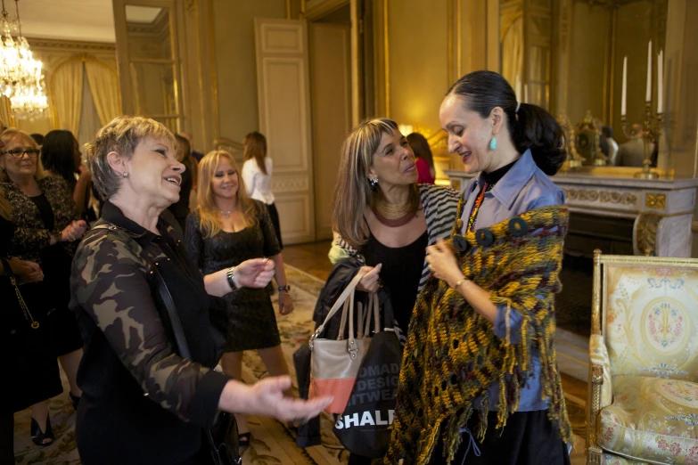 women wearing different colored scarves and looking at each other