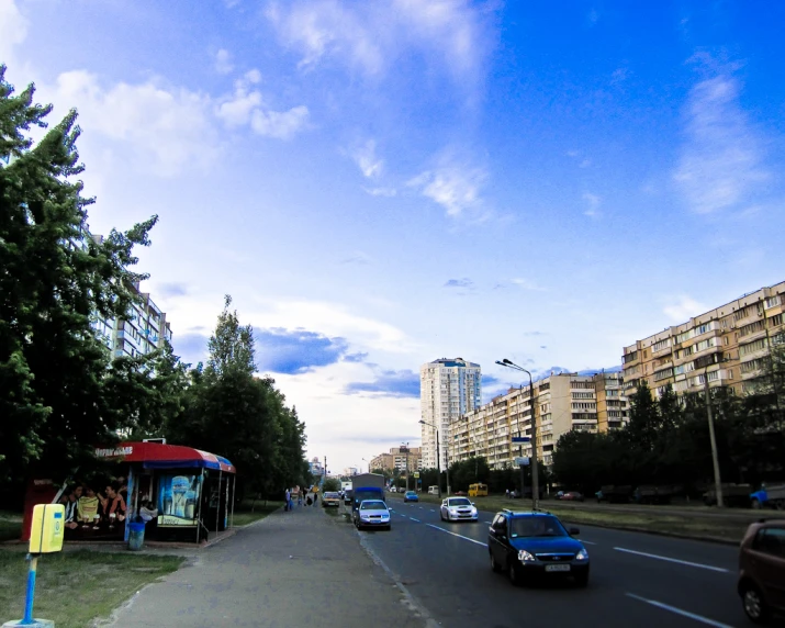 cars are driving down a busy street in a city