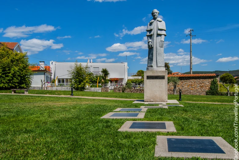 a statue of jesus standing in the middle of the field