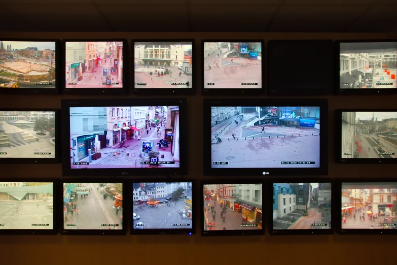seven televisions are seen displaying multiple different scenes