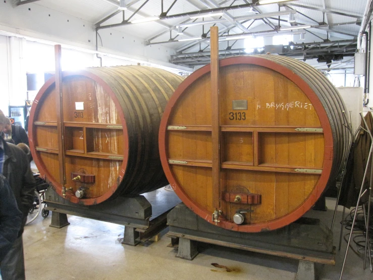 two large barrels sit on top of an assembly line