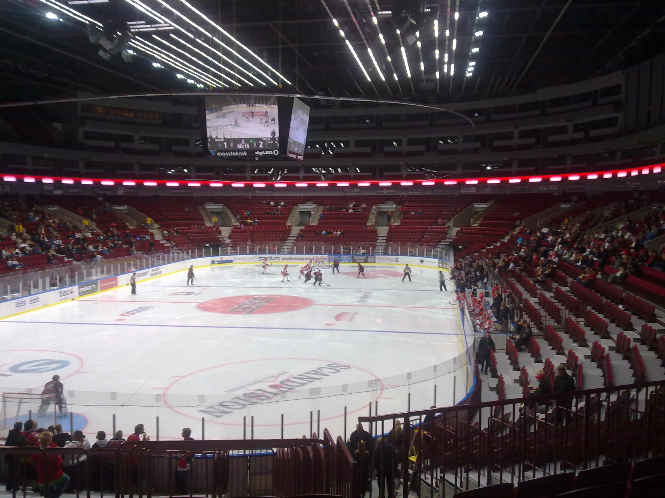 a hockey stadium with lots of people watching the game