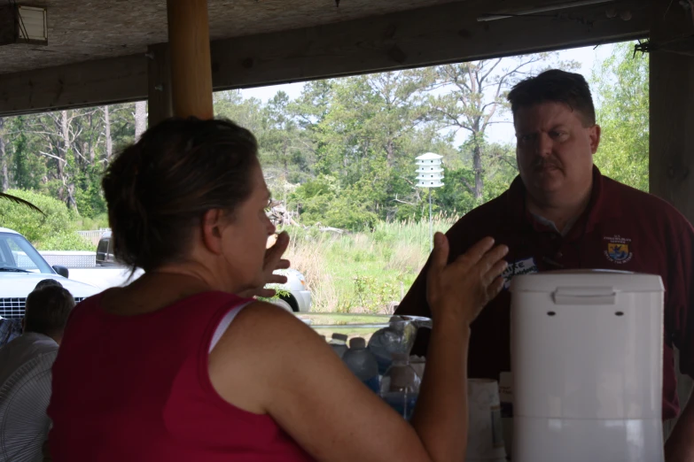 a man and woman standing in front of an icebox