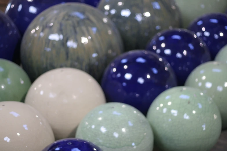 a pile of different color eggs stacked together