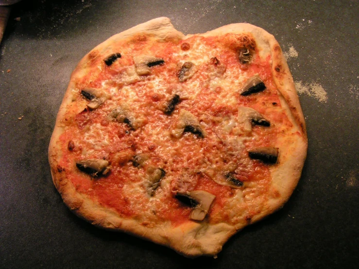 a small pizza with toppings is sitting on top of the grill