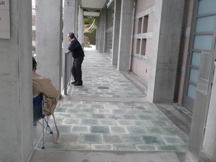 a man is standing in the hallway of an office building