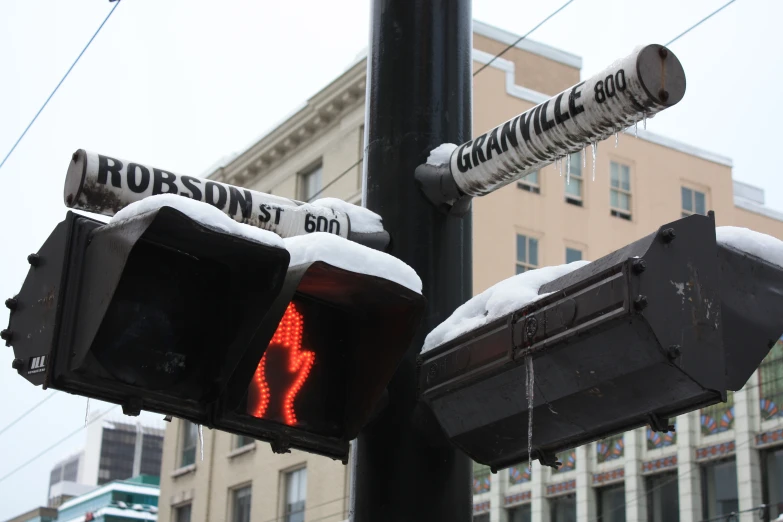 a couple of traffic signals next to buildings