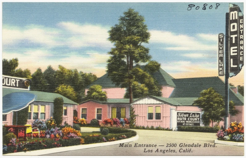 the pink building has a white sign for a restaurant