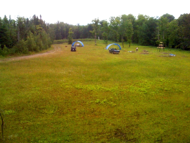 tents are set up in the middle of an open field