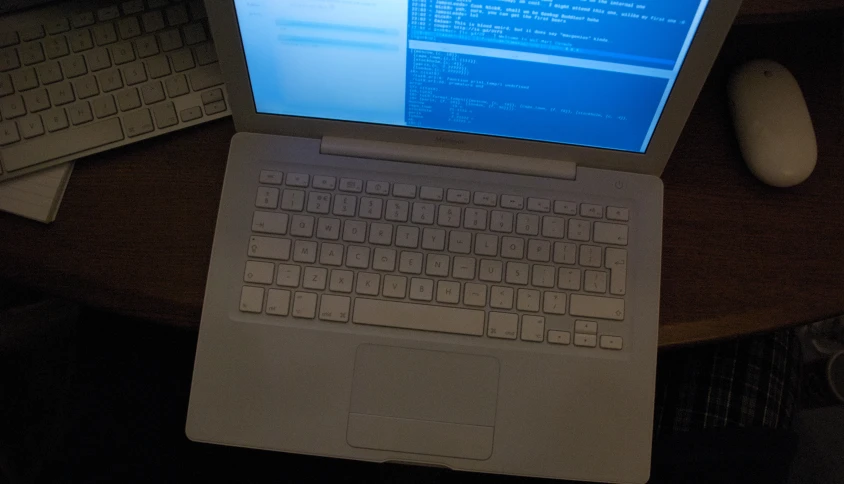 the laptop is open on a computer desk