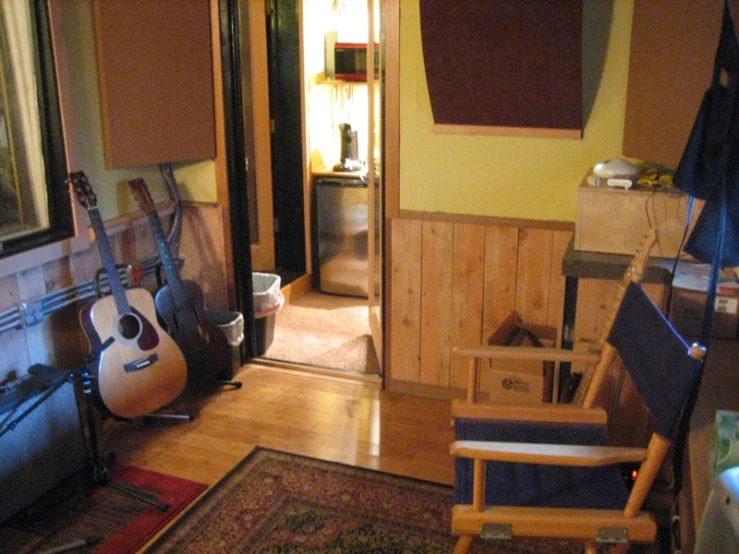guitars sitting on the floor in a cluttered room