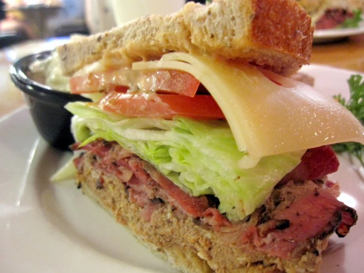 a sandwich with meat and vegetables in a bowl