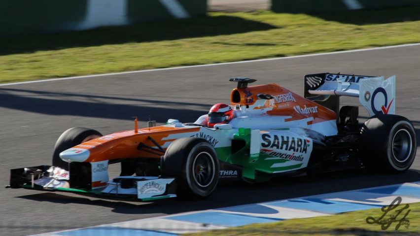 a man driving a racing car on a track