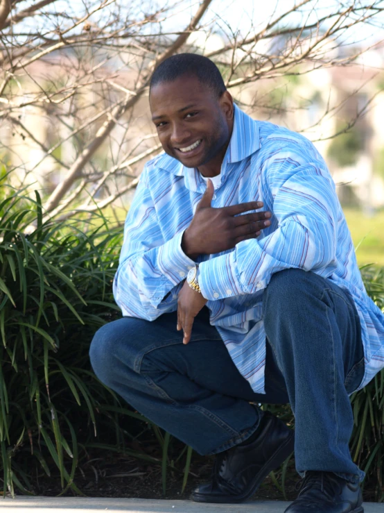 a man leaning down smiling for the camera