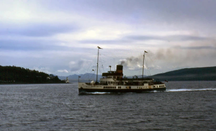 a large boat with sails out on the water