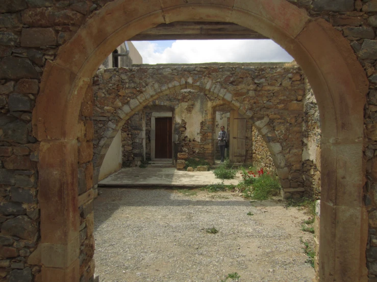 a brick building with an arch on the side