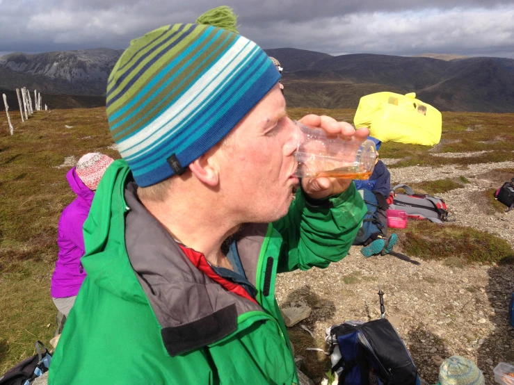 a man drinking wine out of a cup