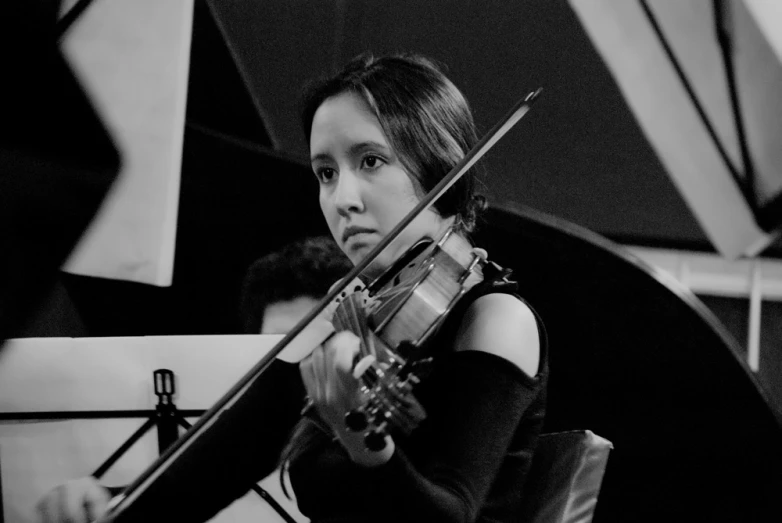 a girl in black playing a violin