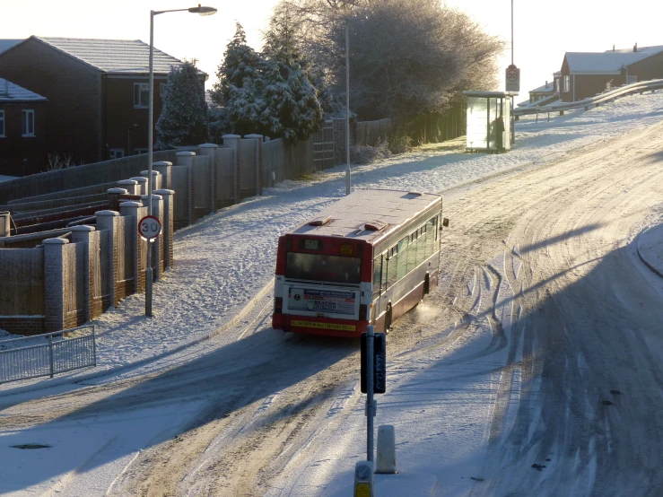 a public transit bus driving along a snowy street