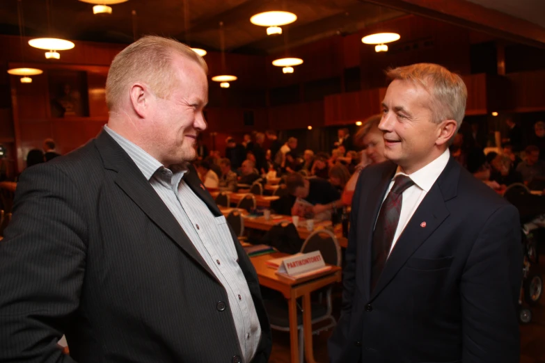 a couple of men standing next to each other