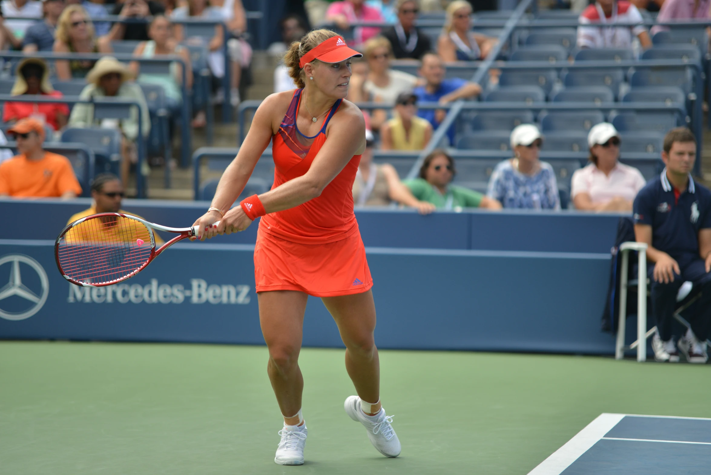 a woman prepares to hit a tennis ball with her racket