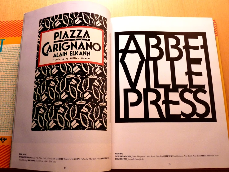 the open book contains a po of an ad for pizza against art