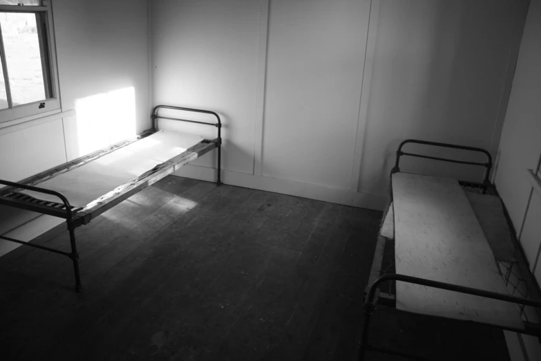 a black and white image of an empty hospital room