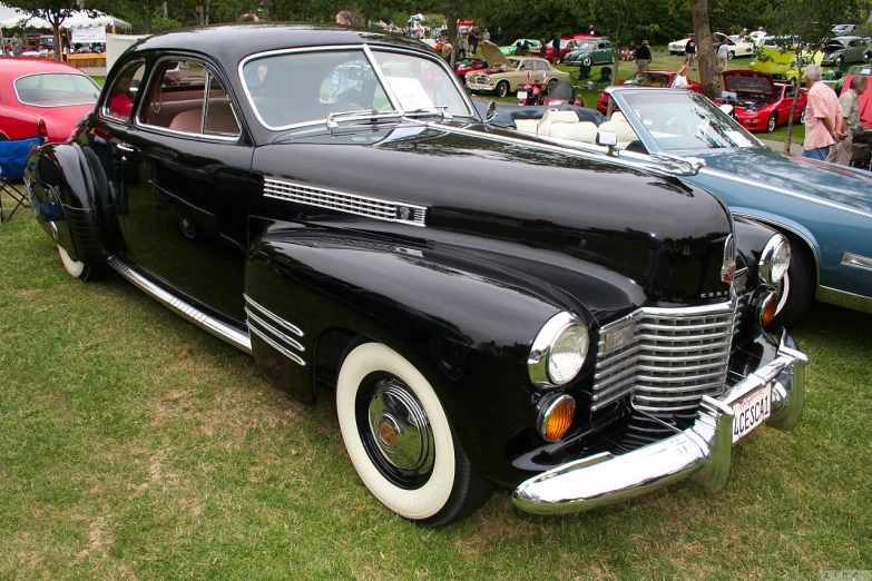 classic black and white automobile on show in a park