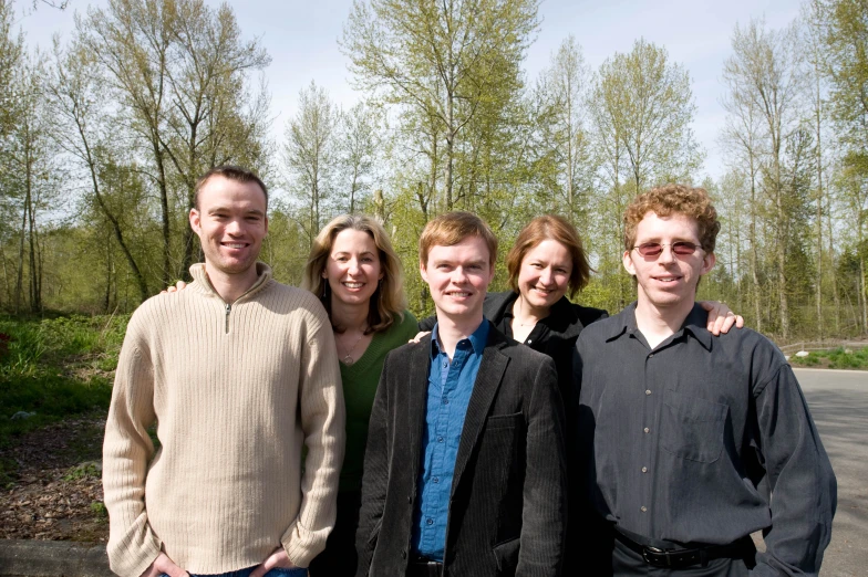 a group of four people pose for the camera