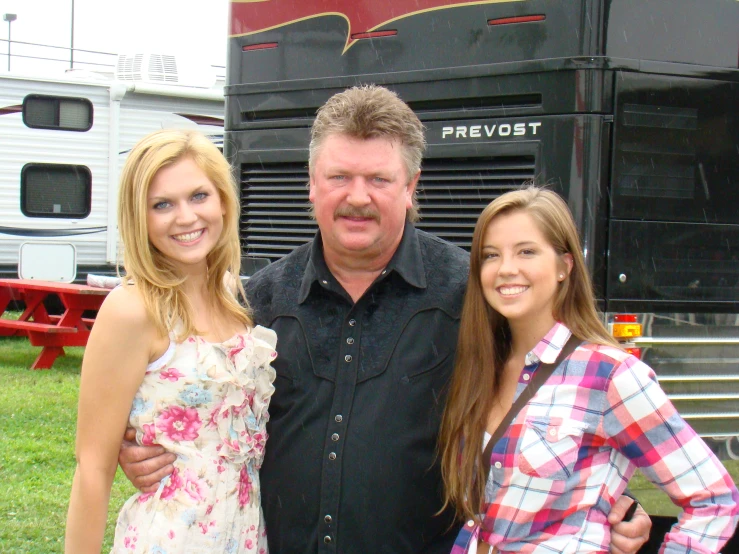 two s and a man standing in front of a trailer