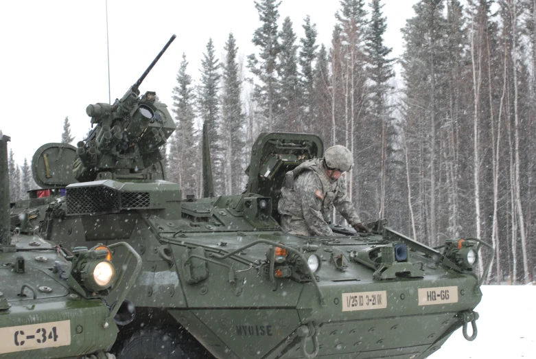 a soldier is sitting on a military vehicle