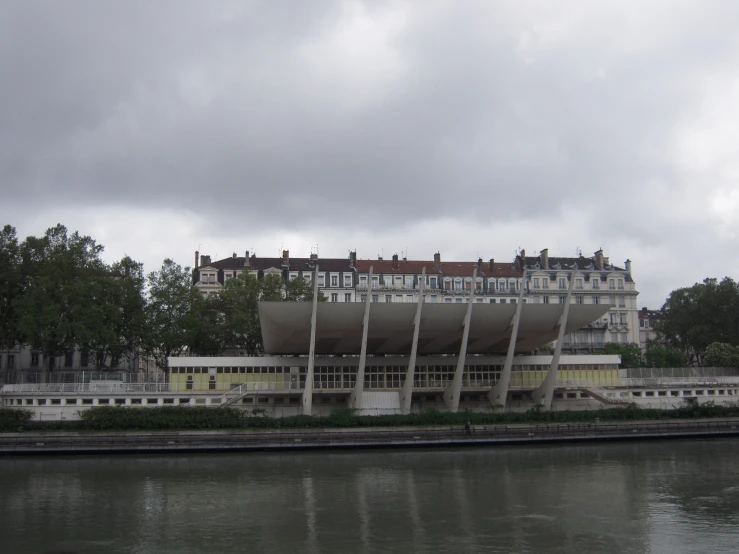 an elaborate building sitting on a riverbank in europe