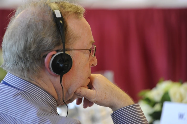 a man with headphones wearing a business shirt