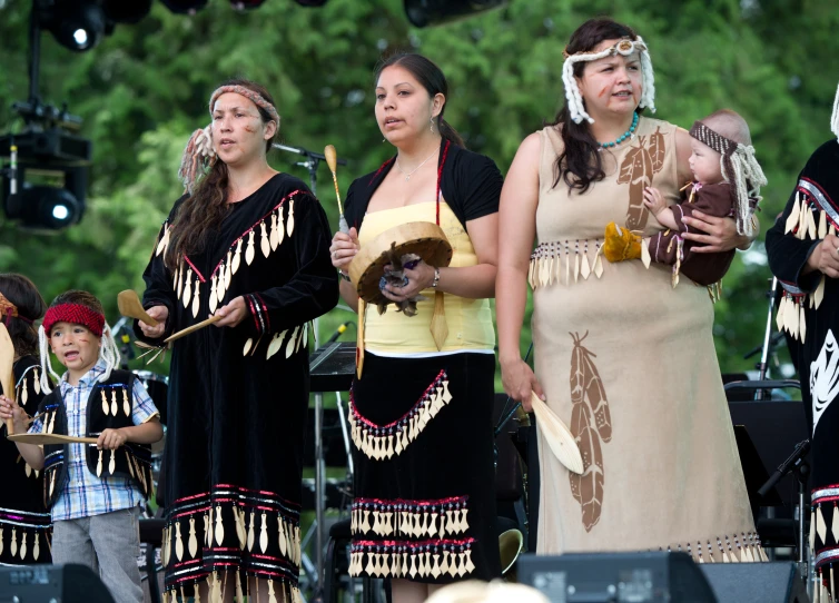 an image of native american people performing in the park